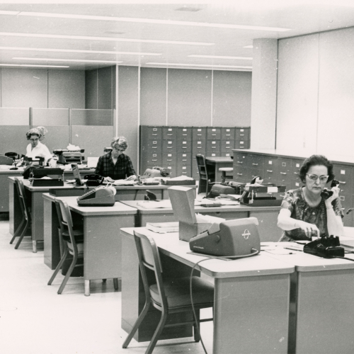 Four women working at desks in an office space