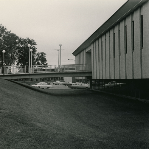 Side view of a building with lower level leading to parking lot and bridge walkway leading into main level