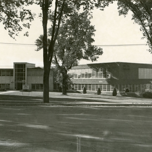 Two-story flat-roofed building with floor-to-ceiling windows