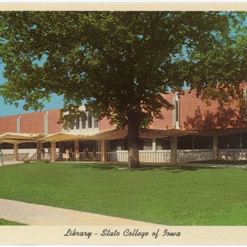 Postcard of red brick and tan stone building with large tree and green lawn in the foreground
