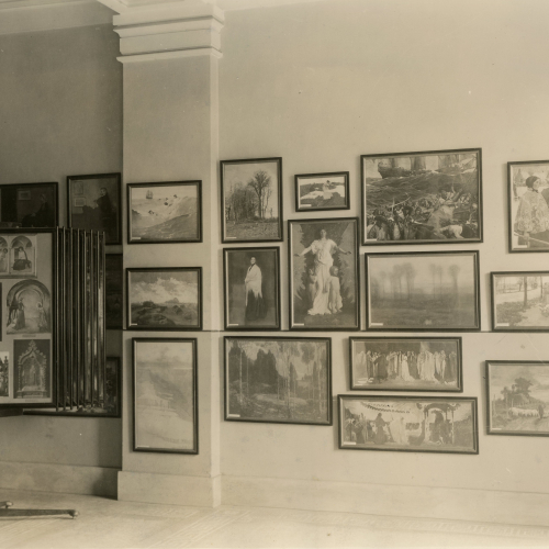 Wall and rack filled with framed reproductions of paintings