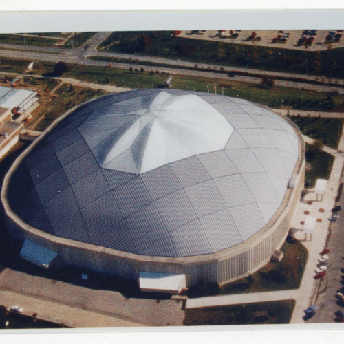Computer model of an oval building with a domed roof made out of two types of material, the center skylight area is lighter-colored