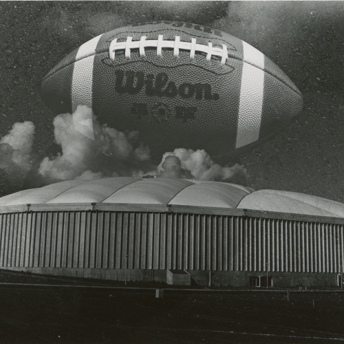 UNI-Dome building with Wilson football superimposed over the top of it