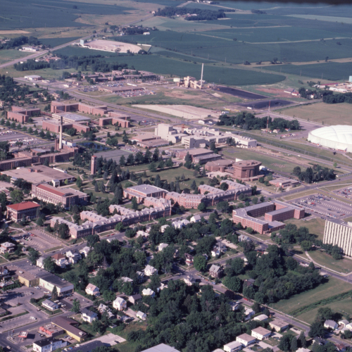 Aerial color shot of campus buildings, UNI-Dome with white fabric-supported roof on the right side