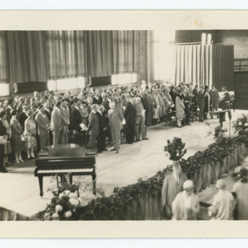 Crowd and piano indoors on stage