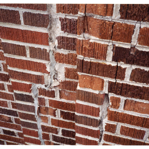 Close-up of damaged brickwork on Campanile near clockface