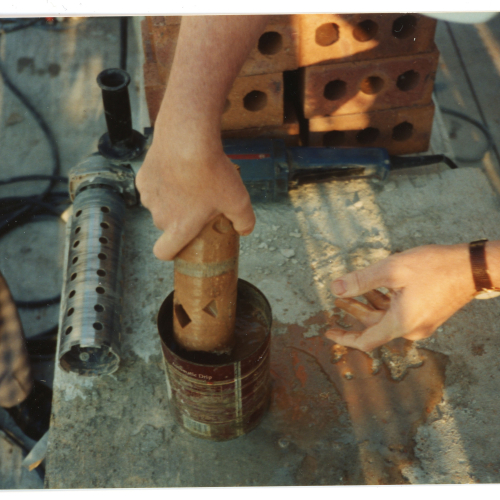 Mason assessing test core of Campanile brick
