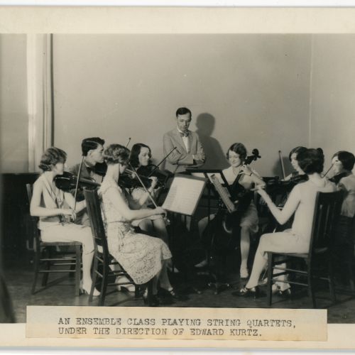 Eight students playing string instruments and one professor, caption reads: an ensemble class playing string quartets, under the direction of Edward Kurtz