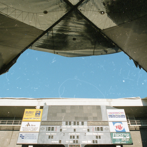 Missing fabric UNI-Dome roof panel, shot is taken from inside on football field looking up and out, scoreboard and sky visible